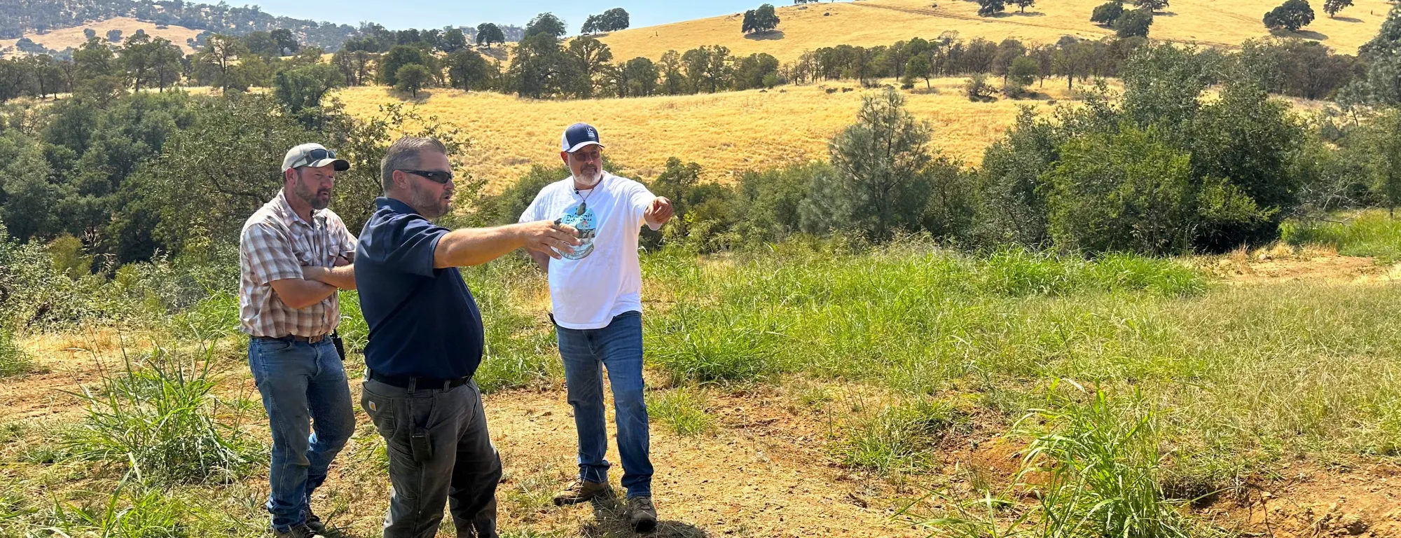 Nikolai Schweitzer gestures at the trench built into a hillside at Sierra Foothill REC