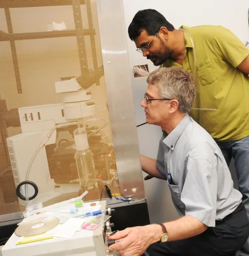 CHEMICAL ECOLOGISTS Walter Leal (foreground) and Zain Syed at work in the Leal lab in the UC Davis Department of Entomology. Leal is a professor and former chair of the department, and Syed is a postdoctoral researcher and the primary author of a paper published March 16 in PLoS One. (Photo by Kathy Keatley Garvey)