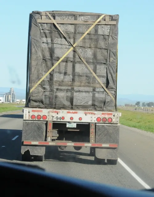 A BEE TRUCK with North Dakota license plates drives through Glenn County, Calif. If beekeepers vote to approve the California Apiary Research Commission, apiaries with more than 50 colonies who do business in California would pay 50 cents per colony to fund honey bee research. (Photo by Kathy Keatley Garvey)