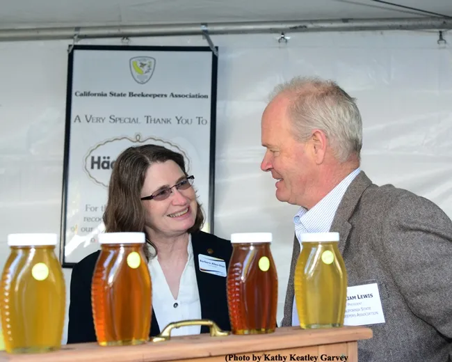 Barbara Allen-Diaz, vice president of UC ANR, "talks bees" with Bill Lewis, president of the California State Beekeepers' Association. (Photo by Kathy Keatley Garvey)