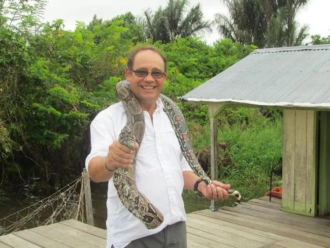 Medical entomologist Anthony Cornel with a snake in Brazil.