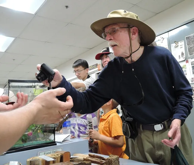 Vedder Wright Jr. of Davis photographs a Madagascar hissing cockroach at the Bohart Museum of Entomology. His father was a friend of the museum founder, noted entomologist Richard Bohart. The Celeste Turner Wright Hall is named for his mother, the first female English professor at UC Davis. It houses the Department of Theatre and Dance. (Photo by Kathy Keatley Garvey)