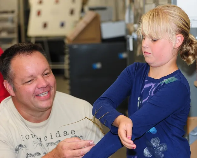 Martin Hauser, senior insect biosystematist, California Department of Food and Agriculture, introduces Lucy Anderson, 9 of Davis to a walking stick. (Photo by Kathy Keatley Garvey)