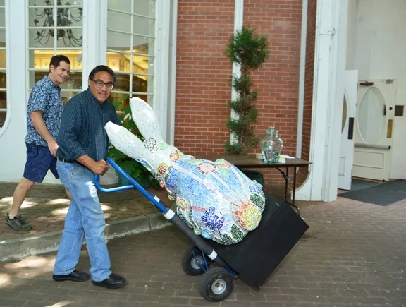 Solano County Supervisor John Vasquez wheels a rabbit back into the museum. In back is Barry Rico. Together they created a "receding hareline." (Photo by Kathy Keatley Garvey)