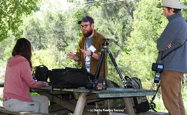 Instructor Thomas Shahan (center) talks photography at BugShot Hastings. He specializes in macro images of jumping spiders. (Photo by Kathy Keatley Garvey)