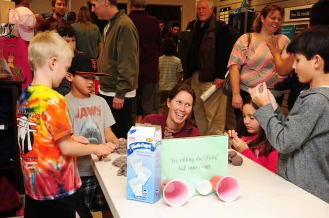 Tabatha Yang, public education coordinator at the Bohart Museum of Entomology, works with visitors.(Photo by Kathy Keatley Garvey)