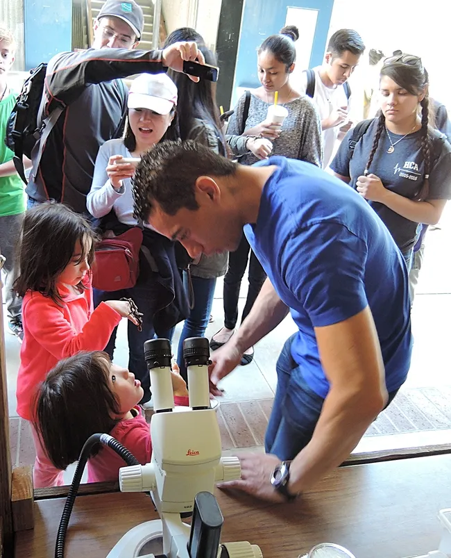 Entomologist Ralph Washington Jr. interacts with visitors outside "The Bug Doctor" booth at Briggs Hall during the UC Davis Picnic Day on April 16. (Photo by Kathy Keatley Garvey)