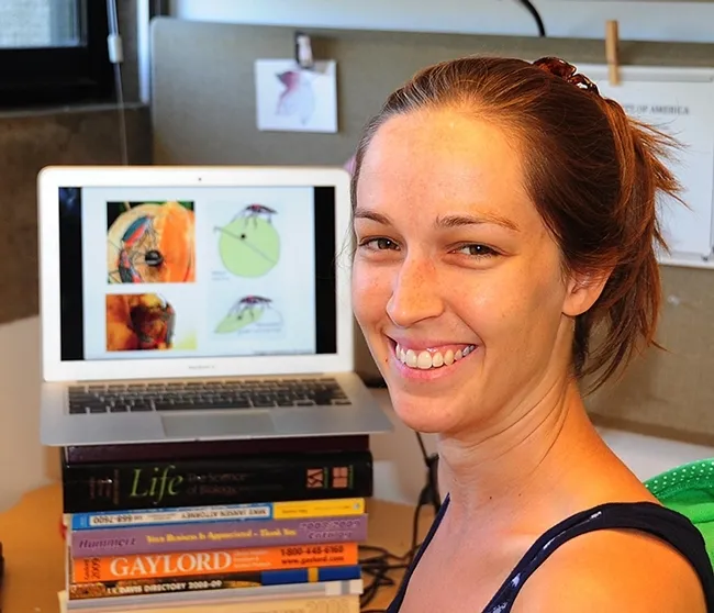 Meredith Cenzer in front of her computer. (Photo by Kathy Keatley Garvey)