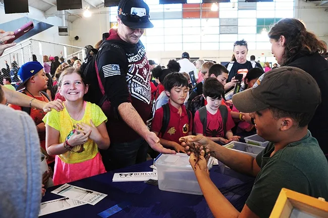 A wide array of expressions at the Bohart Museum booth. At right are Noah Crockette and Tabatha Yang of the Bohart Museum of Entomology. (Photo by Kathy Keatley Garvey)