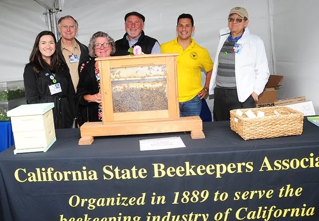 Among those staffing the CSBA booth were (from left) Karli Quinn, CSBA associate director; Eric Mussen, Extension apiculturist emeritus, UC Davis; Gini and Steve Godlin of Visalia (he is the president of CSBA); Bernardo Niño of the E. L. Niño Lab, UC Davis; and Carlen Jupe, CSBA treasurer. (Photo by Kathy Keatley Garvey)