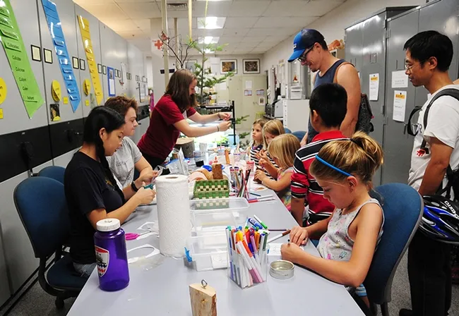 Children flocked to the crafts table to create art focused on bark beetles. (Photo by Kathy Keatley Garvey)