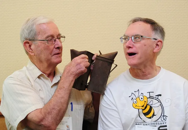 A little fun between friends! Norm Gary (left) playfully aims his smoker at Eric Mussen. Gary retired from UC Davis in 1994 as an apiculture professor, and Mussen in 2014 as an Extension apiculturist. Mussen continues to maintain an office in Briggs Hall, UC Davis. (Photo by Kathy Keatley Garvey)