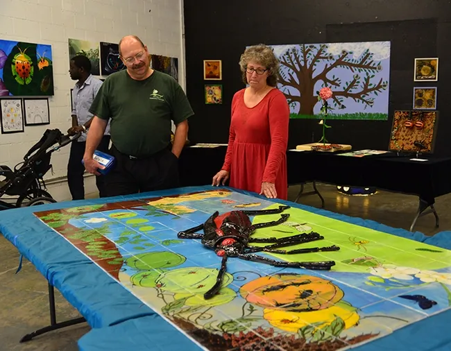 Entomologist-artist Diane Ullman, UC Davis professor of entomology, looks over insect art with fellow UC Davis faculty affiliate Steve Seybold, research entomologist with the Pacific Southwest Research Station, U.S. Department of Food and Agriculture. The occasion: a show to showcase the work of Ullman's students in 2015 in Entomology 1. (Photo by Kathy Keatley Garvey)