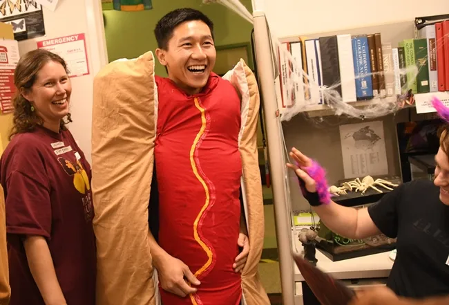 Student Jamie Fong came dressed as a hot dog. At left is Tabatha Yang, Bohart Museum outreach and public education coordinator, dressed as a "staff infection." (Photo by Kathy Keatley Garvey)
