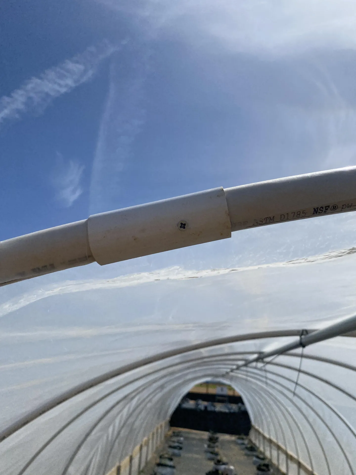 Figure 11. To help hold the plastic in place, the PVC clamp was secured to the PVC hoop using a 1 ¼” Phillips head wood screw.