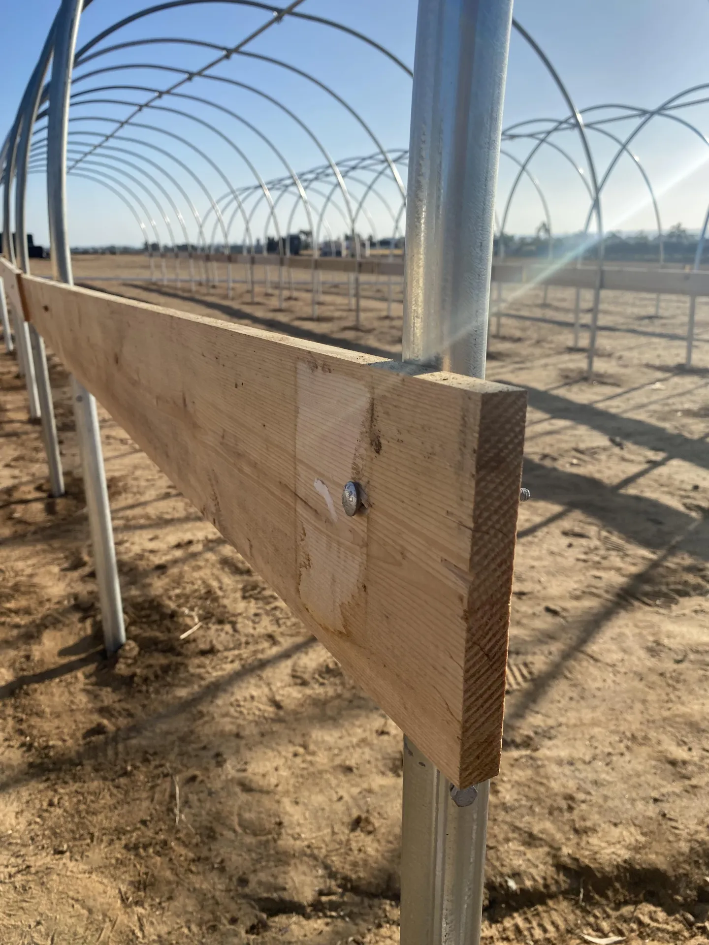 Figure 5. The hip board is installed on the outside of the high tunnel and secured with a 4 in carriage bolt.