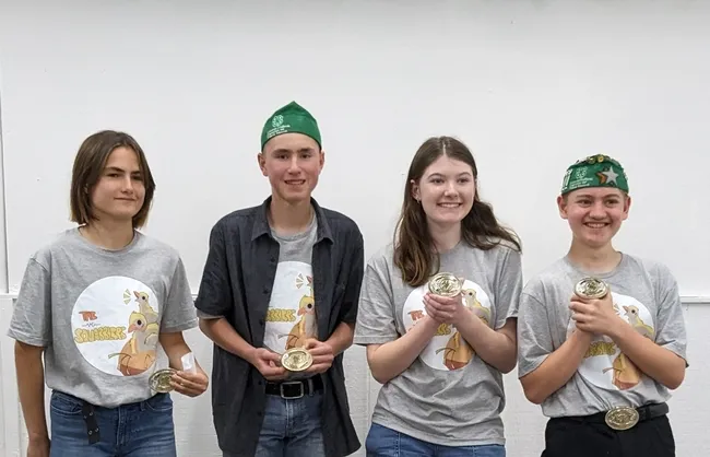 4 youth holding their awards.