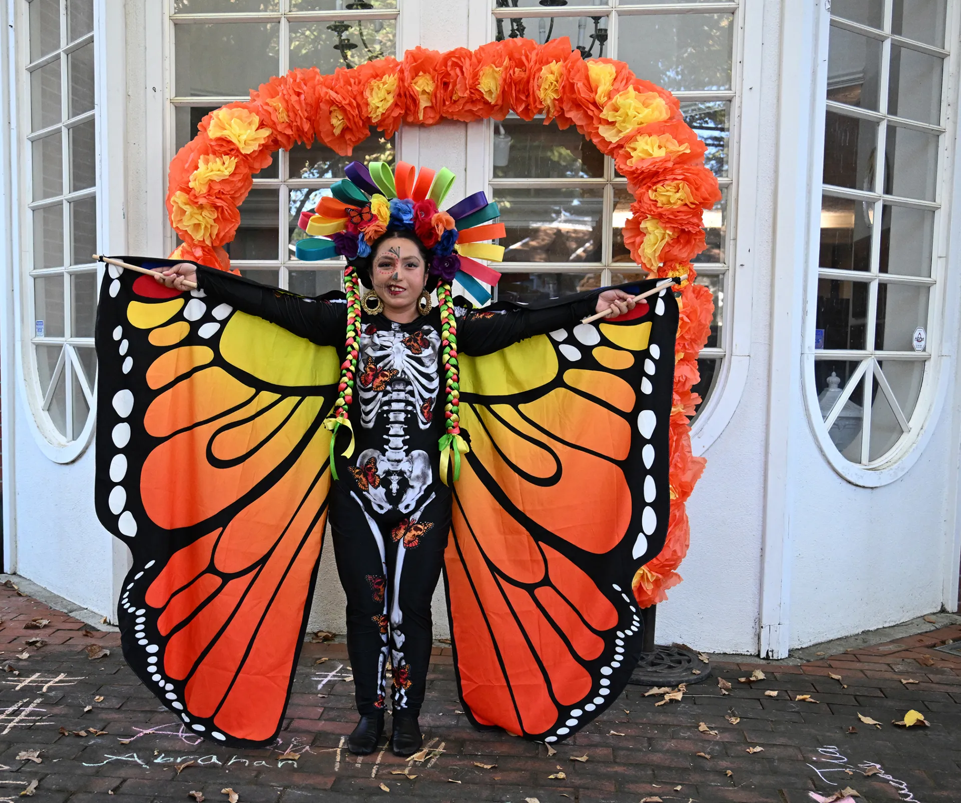 A Ballet Folklorico Netzahualcoyotl dancers displays her monarch gown. (Photo by Kathy Keatley Garvey)