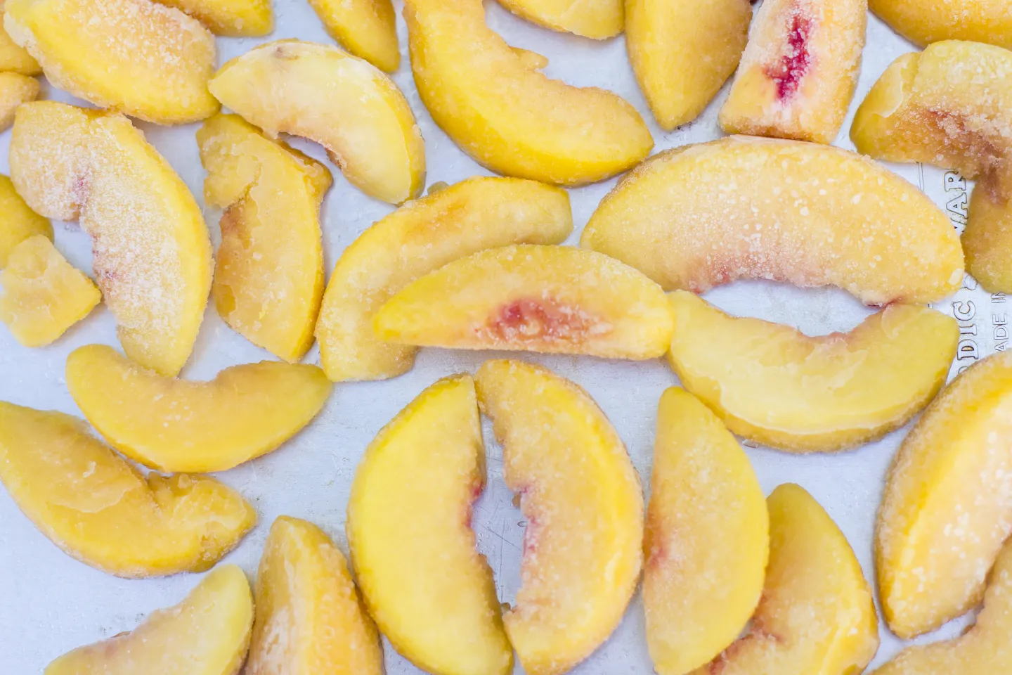 Individual Quick Freeze method- frozen peaches on tray. 