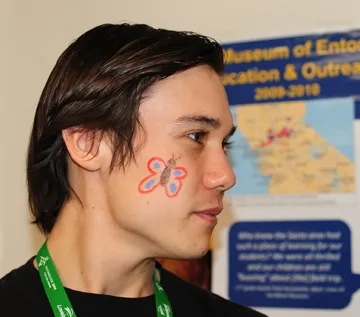 UC Davis graduate student Alex Dedmon, who studies with forensic entomologist Robert Kimsey, shows his butterfly tattoo. (Photo by Kathy Keatley Garvey)