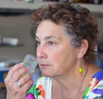 Amina Harris gives a jar of honey the