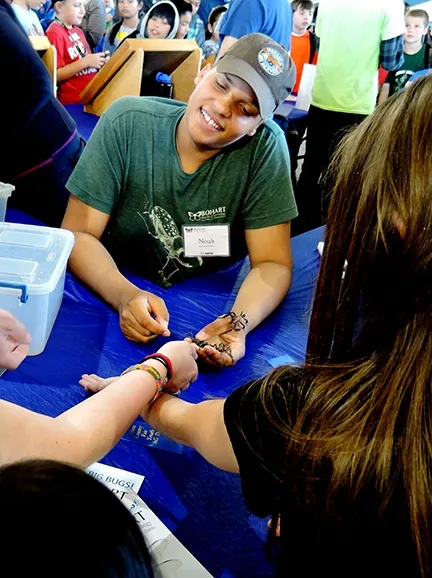 At times, it seemed like every hand held an insect. That's Noah Crockette holding forth. (Photo by Kathy Keatley Garvey)