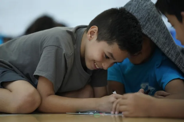 Smiles all around while learning computational thinking with Hack Your Harvest.