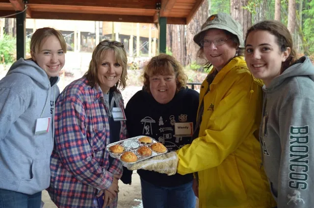 Five women with muffins