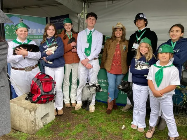 Eight 4-H'ers pose proudly with Senator Marie Alvarado-Gil.