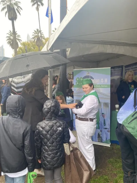 Assemblymember Megan Dahle pets a black rabbit held by a 4-H youth.