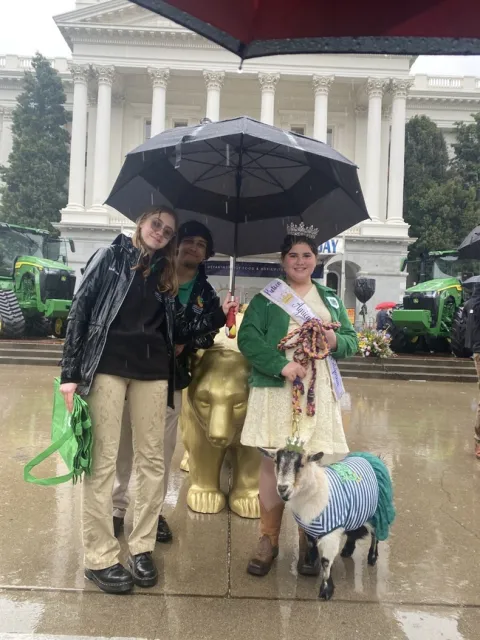 State Ambassadors, Tejas and Isabelle pose with Preteen Miss Agriculture of America California, Arianna and her goat.