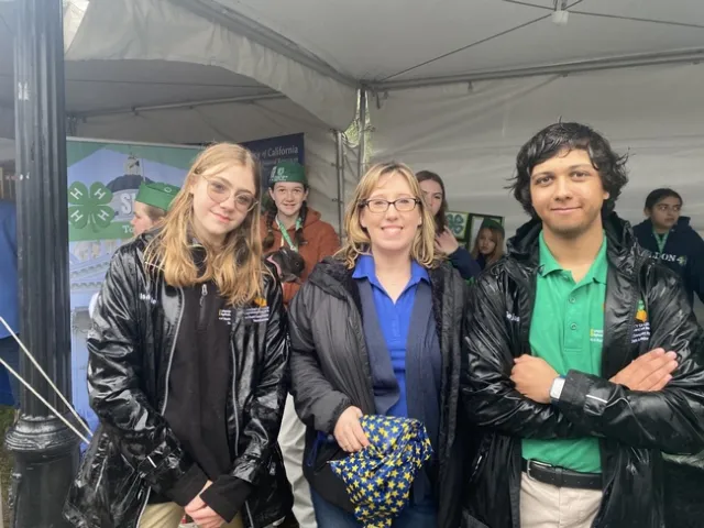 State Ambassadors Tejas and Isabelle stand with Erica Pettey.