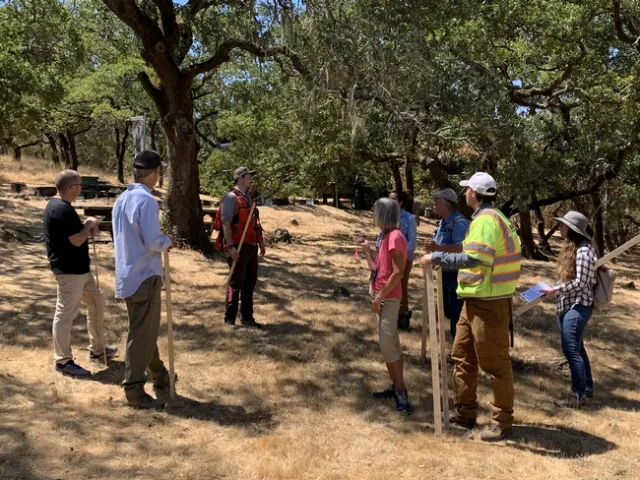 Forestry advisor talks with a workshop group in an oak woodland