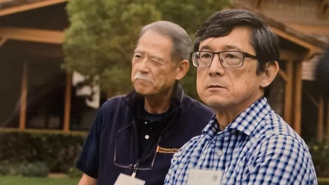 Two men sitting side by side.