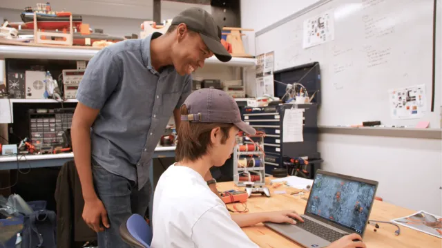 Members of the Olin College of Engineering team work on their autonomous mechanical weeding system