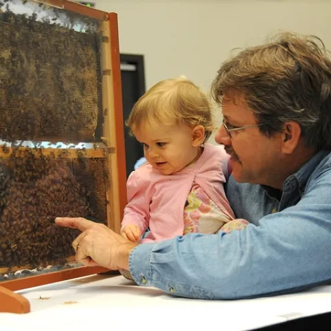 Future beekeeper Emily Fishback with her beekeeper-father Brian Fishback of Wilton, who provided the bee observation hives. (Photo by Kathy Keatley Garvey)