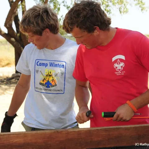Derek Tully (right) and fellow scout Willie Hawkins work on the fence surrounding the half-acre pollinator garden. (Photo by Kathy Keatley Garvey)