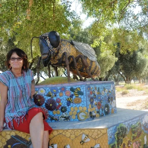 UC Davis Art/Science Fusion co-founder and co-director Donna Billick with her mosaic ceramic sculpture, Miss Bee Haven, in the half-acre Haagen-Dazs Honey Bee Haven on Bee Biology Road, UC Davis. (Photo by Kathy Keatley Garvey
