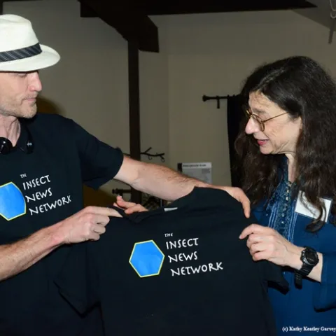 Emmet Brady, shown here with May Berenbaum, talks about the meaning of the Insect News Network t-shirt. (Photo by Kathy Keatley Garvey)