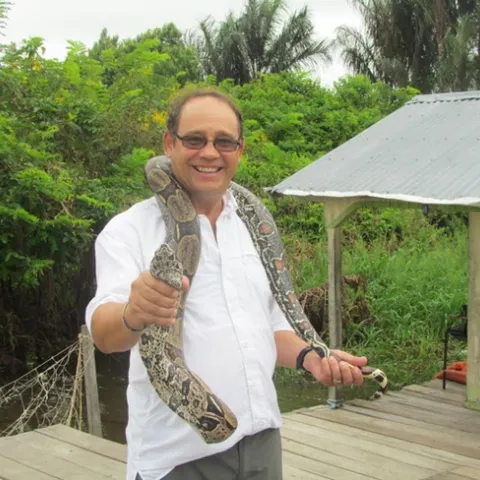 Medical entomologist Anthony Cornel with a snake in Brazil.