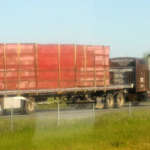 A truck loaded with bee hives. Image taken through a car window. (Photo by Kathy Keatley Garvey)