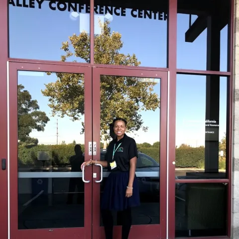 Eve outside at doorway to Valley Conference Center