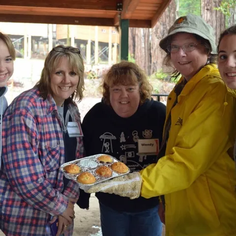 Five women with muffins