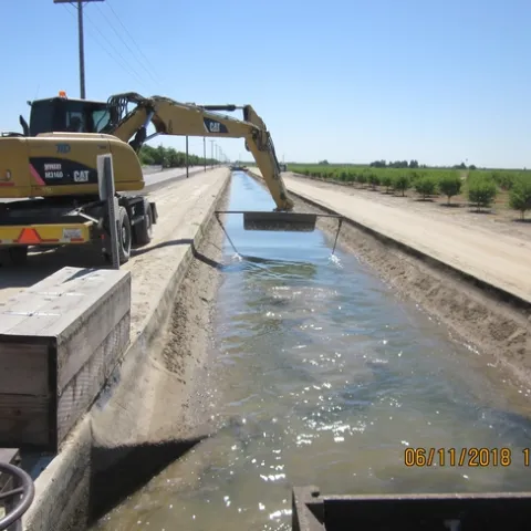 Removing seeds from irrigation canal near Tulare, CA using chaining