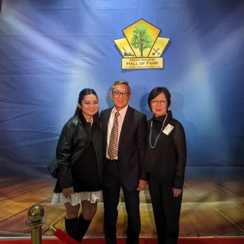 A family photo with a wife, husband and daughter.