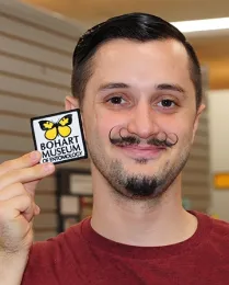 Wade Spencer with Bohart Museum patch, available in the museum gift shop. (Photo by Kathy Keatley Garvey)