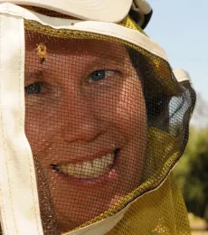 With a bee on her veil, camp coordinator Tabatha Yang is shown here in a 2011 photo at the Harry H. Laidlaw Jr. Honey Bee Research Facility. (Photo by Kathy Keatley Garvey)