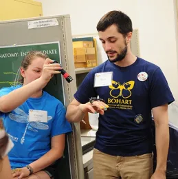 Before: Crystal Homicz gets ready to shine a black light on Wade Spencer's scorpion. (Photo by Kathy Keatley Garvey)