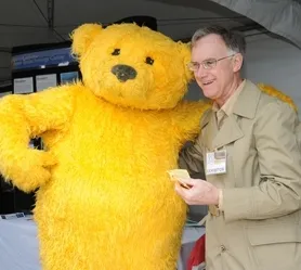Extension apiculturist Eric Mussen offers honey to Poppy, the California State Fair mascot at last year's Ag Day. (Photo by Kathy Keatley Garvey)