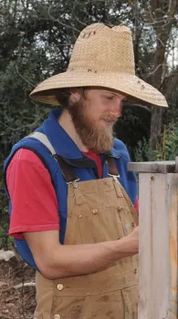 Derek Downey working in the Davis Bee Sanctuary. (Photo by Kathy Keatley Garvey)